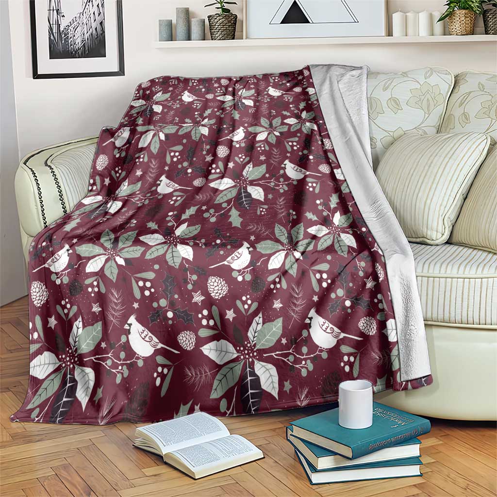Wine red Christmas blanket with white bird and poinsettia floral pattern.