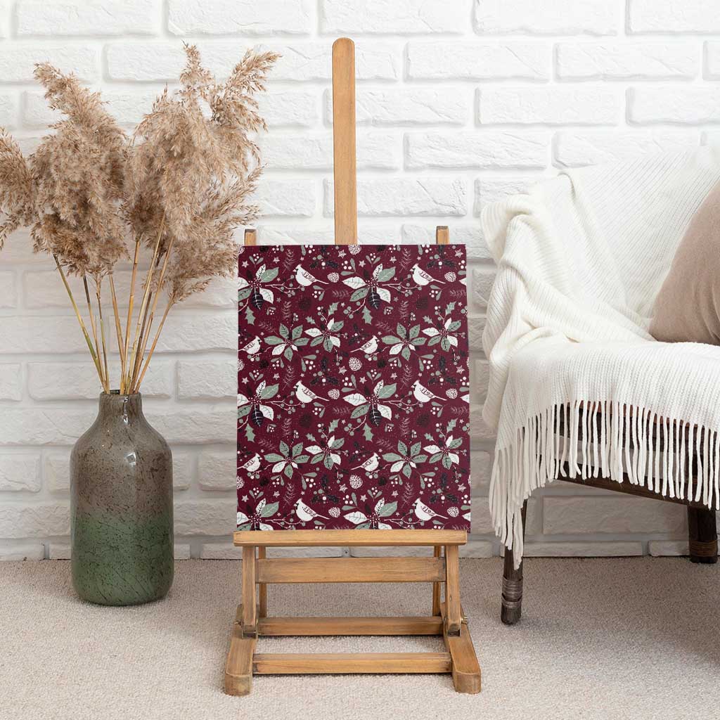 Wine red canvas wall art displayed upright on a wooden easel with holiday bird pattern