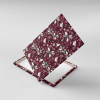Wine red canvas wall art with layered view of white cardinal and poinsettia holiday pattern