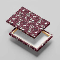 Wine red canvas wall art shown from a corner with white cardinal and poinsettia motif