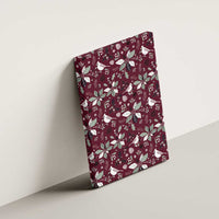 Wine red canvas wall art tilted on wall with white cardinal and poinsettia holiday pattern
