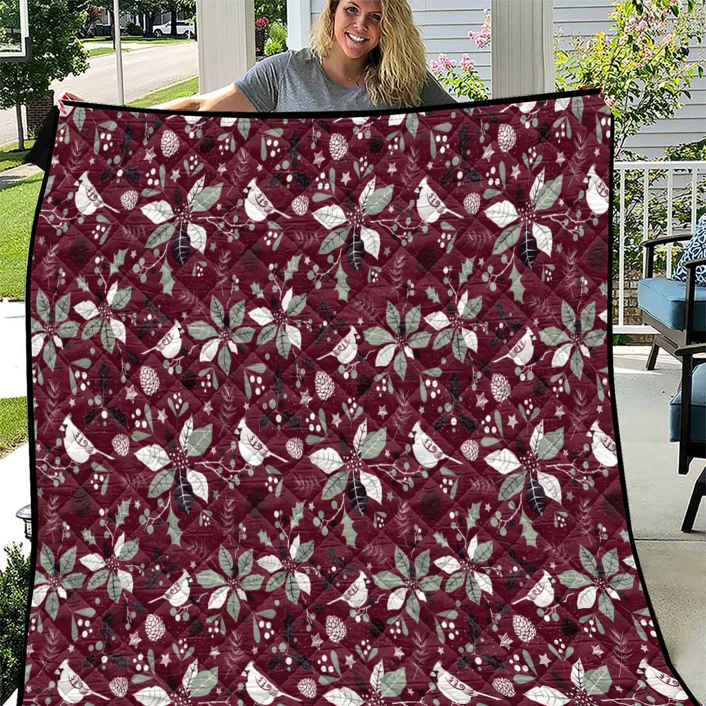 Wine red Christmas quilt with white poinsettia and snowflake pattern, quilted border