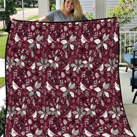 Wine red Christmas quilt with white poinsettia and snowflake pattern, quilted border