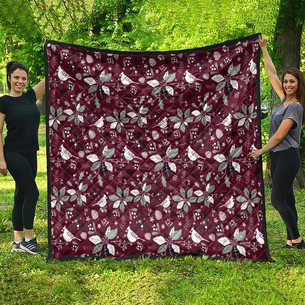 Wine red Christmas quilt showing large white poinsettia and bird pattern, full view