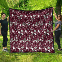 Wine red Christmas quilt showing large white poinsettia and bird pattern, full view
