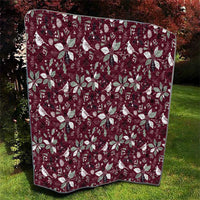 Wine red Christmas quilt with white poinsettia and bird motifs, square stitched corners