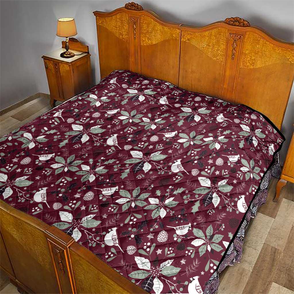 Wine red Christmas quilt with white poinsettia and bird print, on a bed