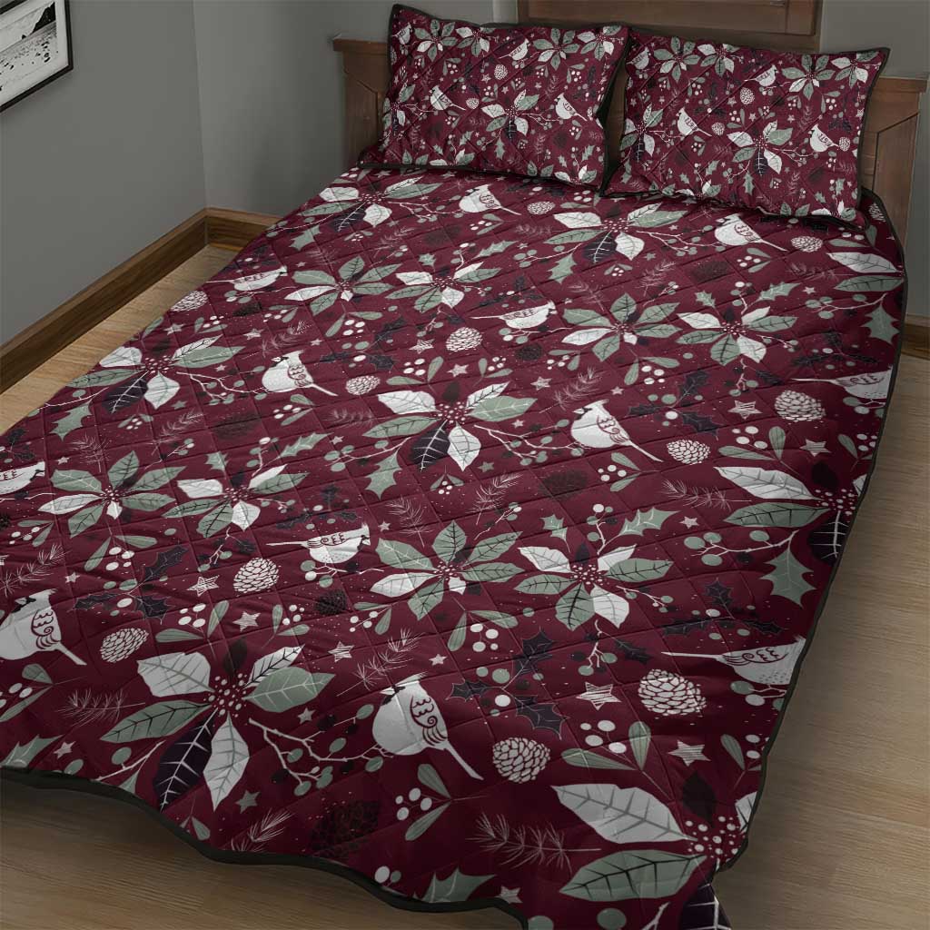 Wine red quilt bed set with holly leaf, flower, bird, and star pattern on bed with shams