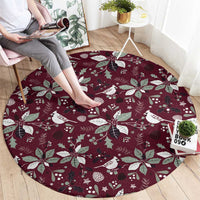 Wine red round rug with white Christmas birds, pine leaves, and star motifs