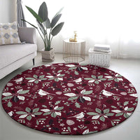 Wine red round carpet with scattered white poinsettias, leaves, and bird figures