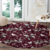 Wine red round carpet with white bird and poinsettia pattern, full surface view