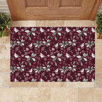 Wine red rubber doormat with festive birds, poinsettias, and snowflake pattern