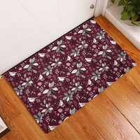 Wine red rubber doormat with holiday bird and poinsettia pattern, corner view