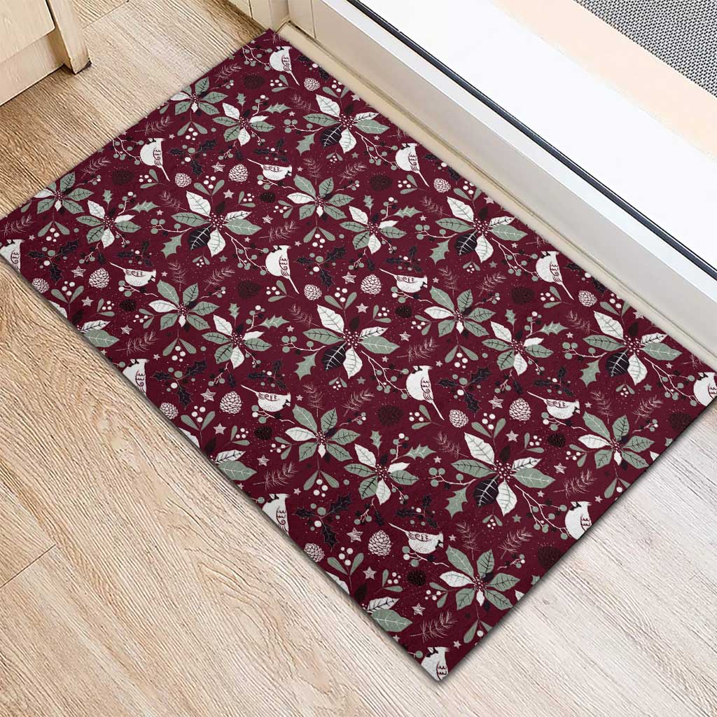 Wine red rubber doormat with repeating holiday birds and poinsettias pattern
