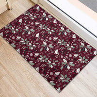 Wine red rubber doormat with repeating holiday birds and poinsettias pattern
