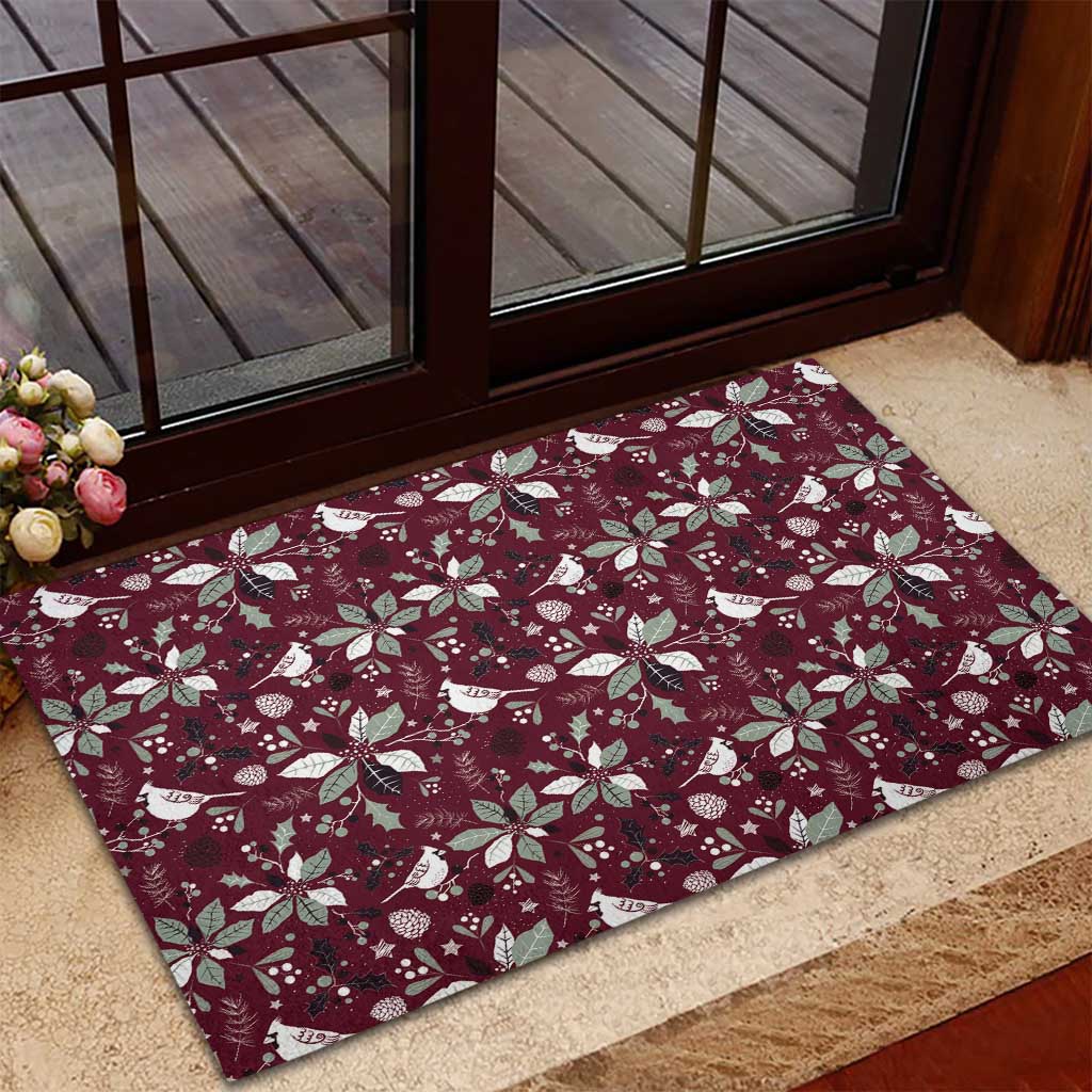 Wine red rubber doormat with festive bird and poinsettia pattern near door