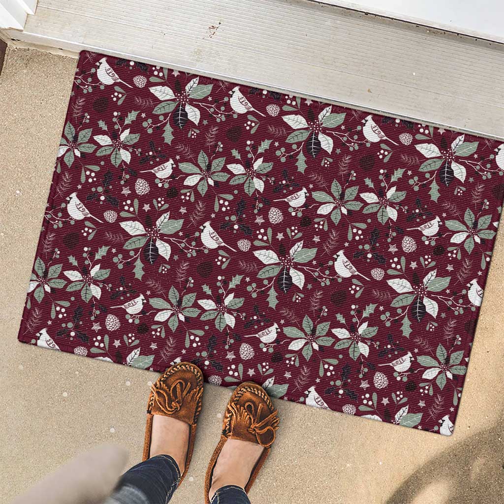 Wine red rubber doormat with holiday birds, poinsettias, and snow motif pattern