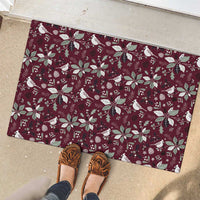 Wine red rubber doormat with holiday birds, poinsettias, and snow motif pattern