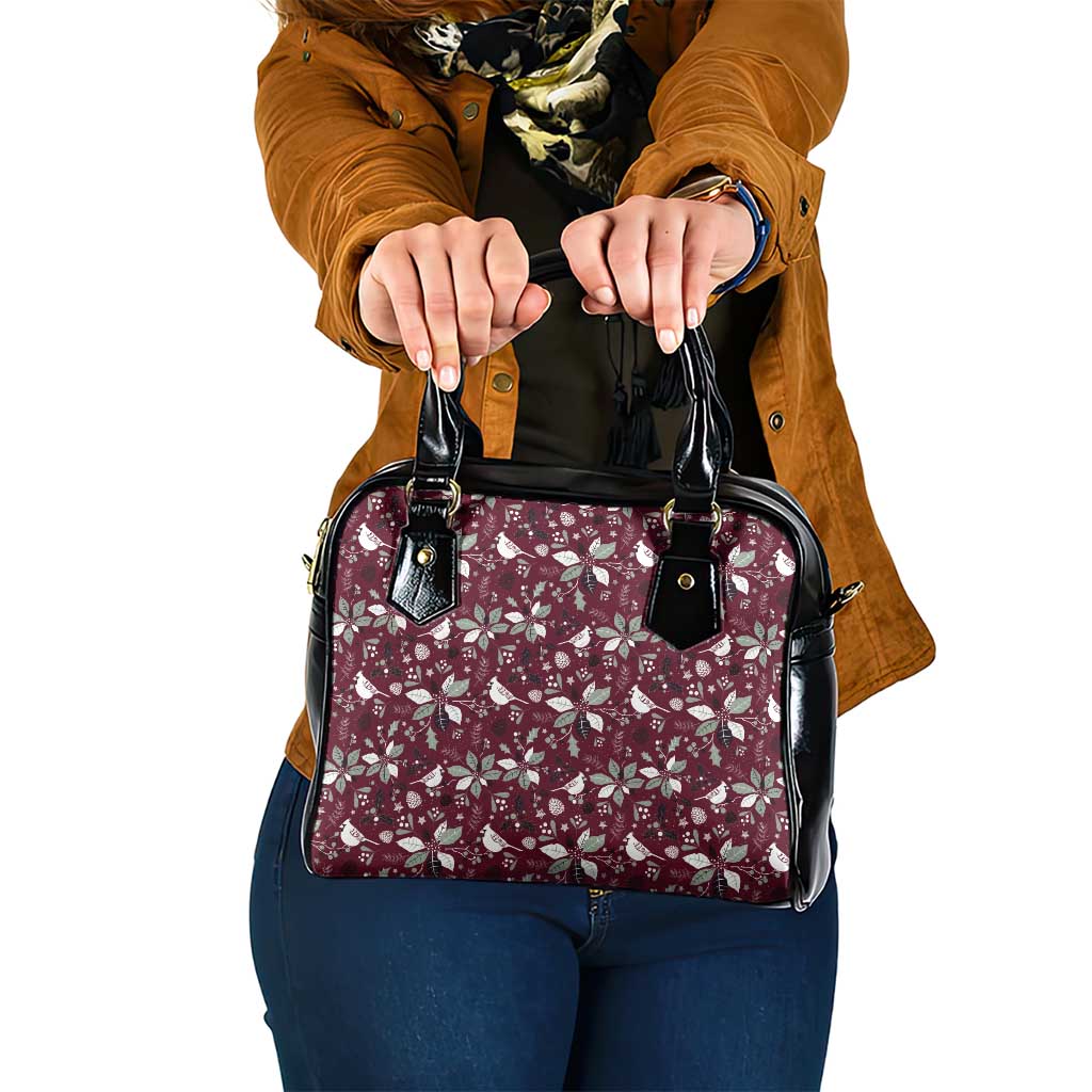 Wine red floral shoulder handbag with black handles and zipper pulls