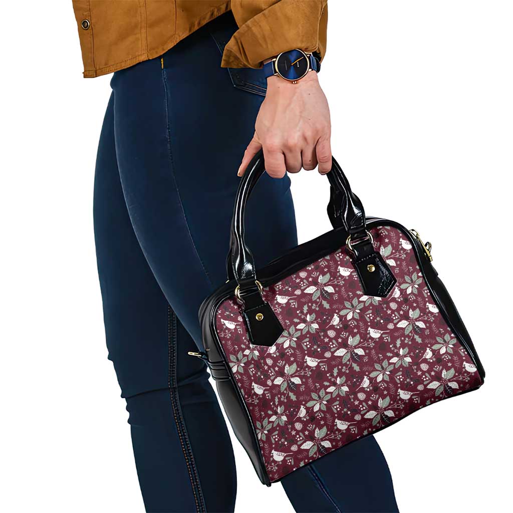 Wine red floral shoulder handbag with black trim, side view