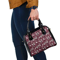 Wine red floral shoulder handbag with black trim, side view