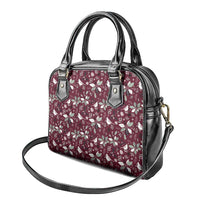 Wine red floral satchel handbag with black handles and crossbody strap