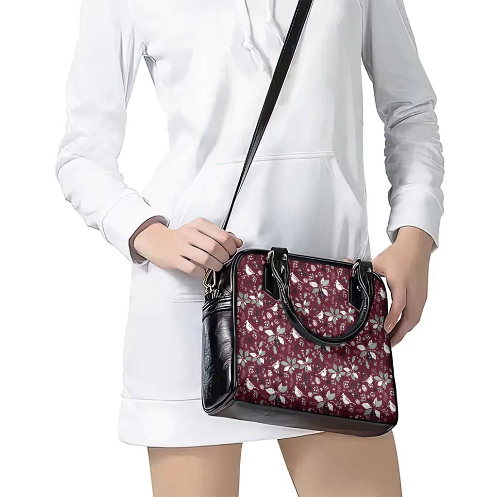 Wine red floral handbag with black crossbody strap and top handles