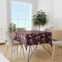 Wine red Christmas tablecloth with repeating poinsettia and holly motifs on dining table