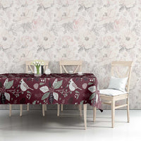 Wine red Christmas tablecloth with poinsettia and holly motifs, set on dining table