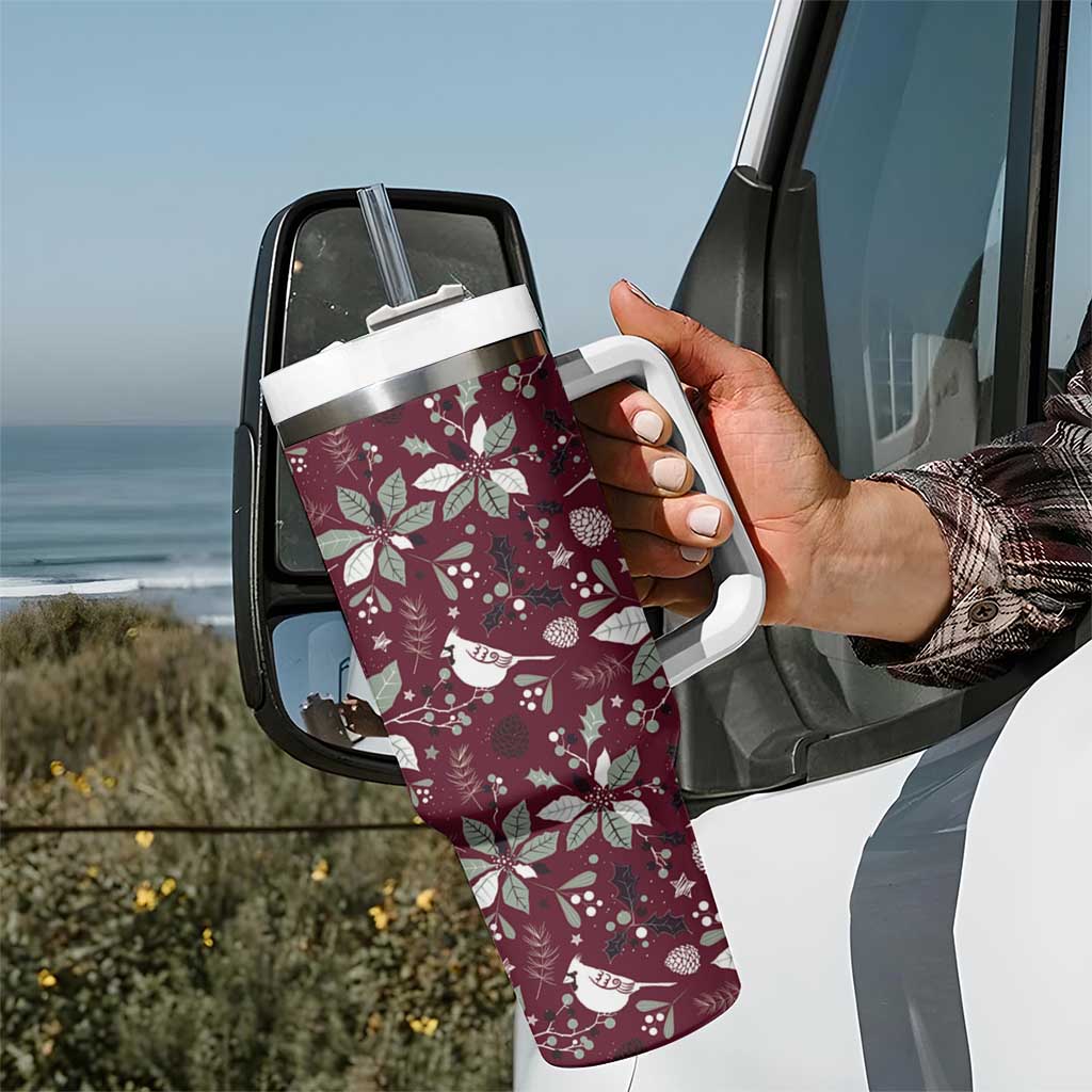 Wine red handled tumbler with clear straw and white holiday pattern, held up