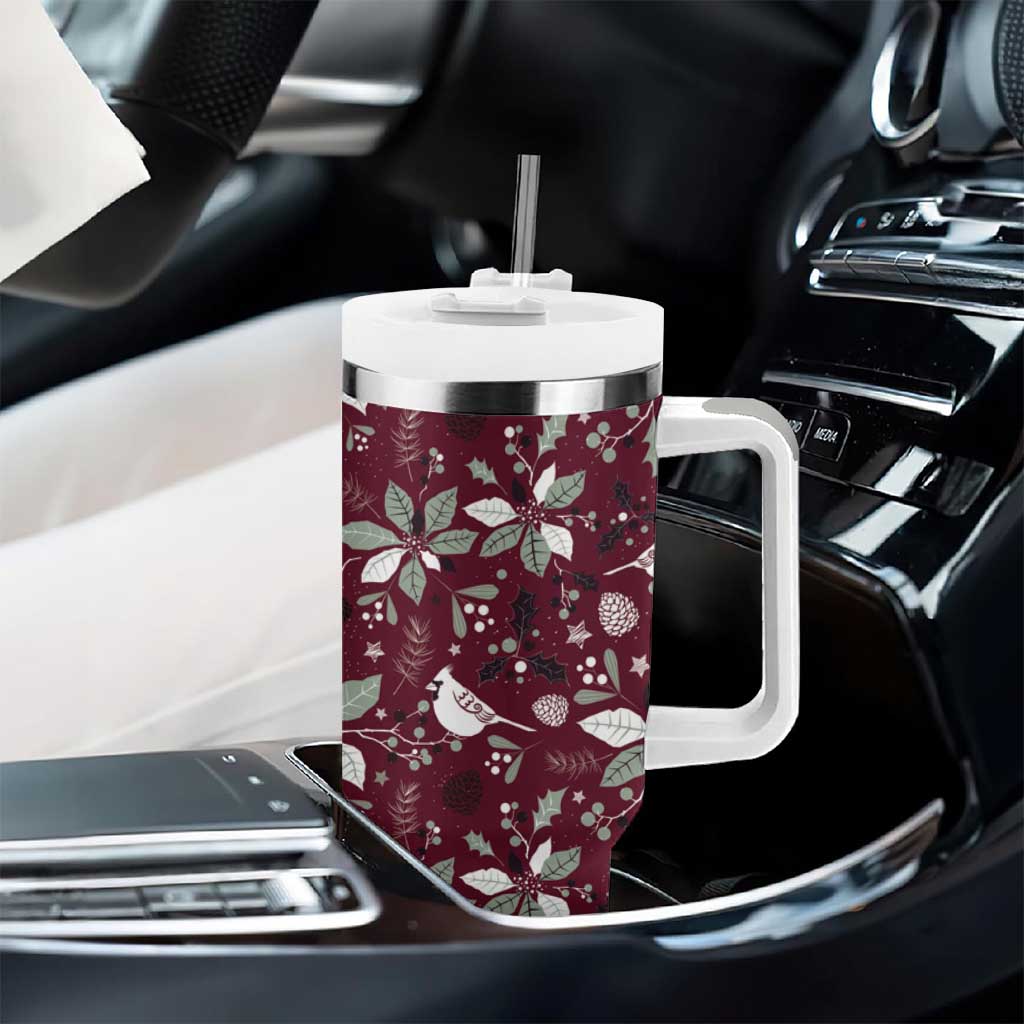Wine red tumbler with white handle, clear straw, and white holiday pattern in vehicle