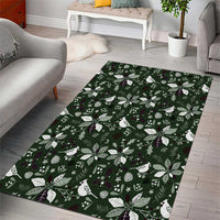 Rectangular green area rug with bold holiday leaf and flower print, white and purple accents