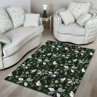 Rectangular green area rug with repeating holiday leaf and flower design, white and purple accents