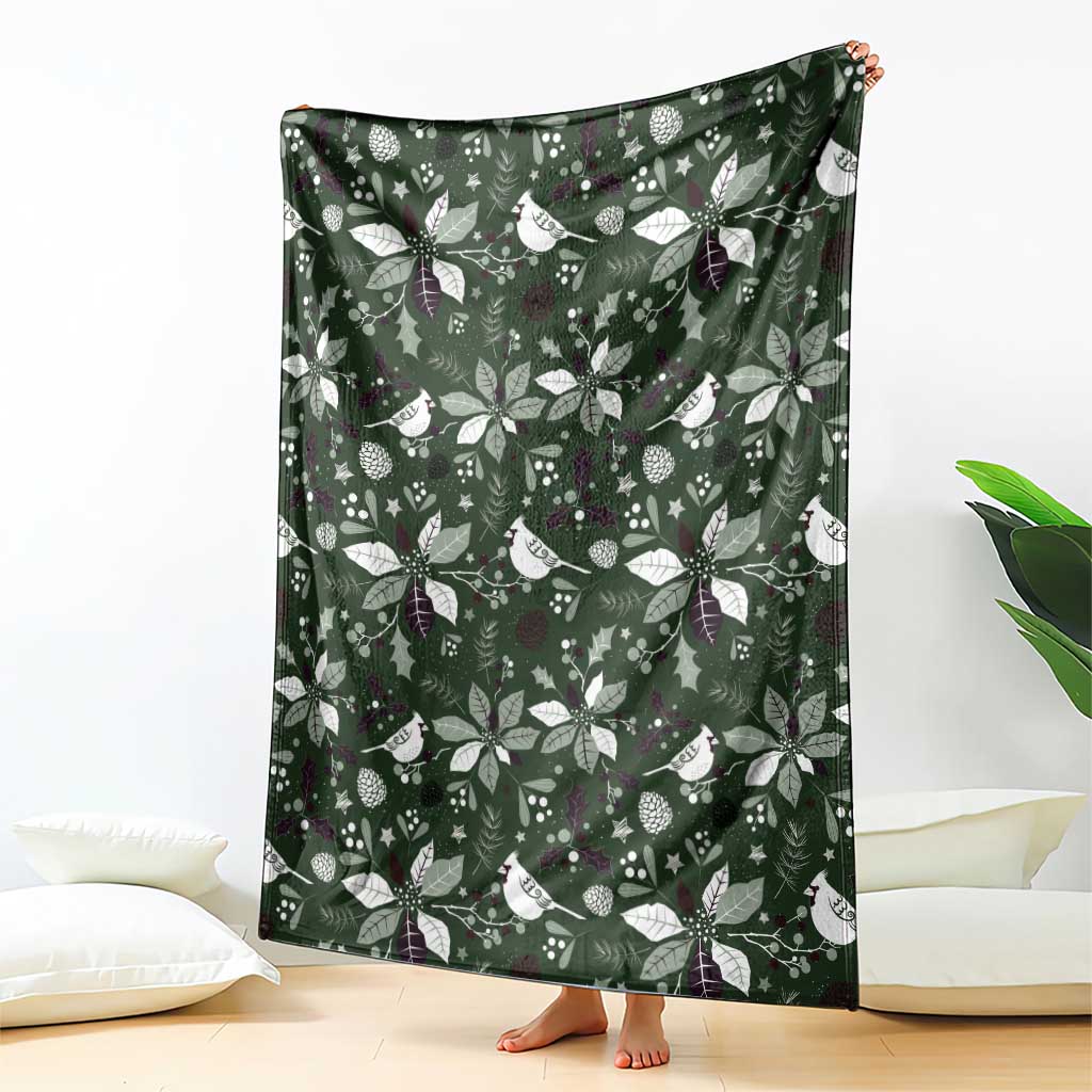 Green patterned blanket draped upright with white birds, leaves, and small stars