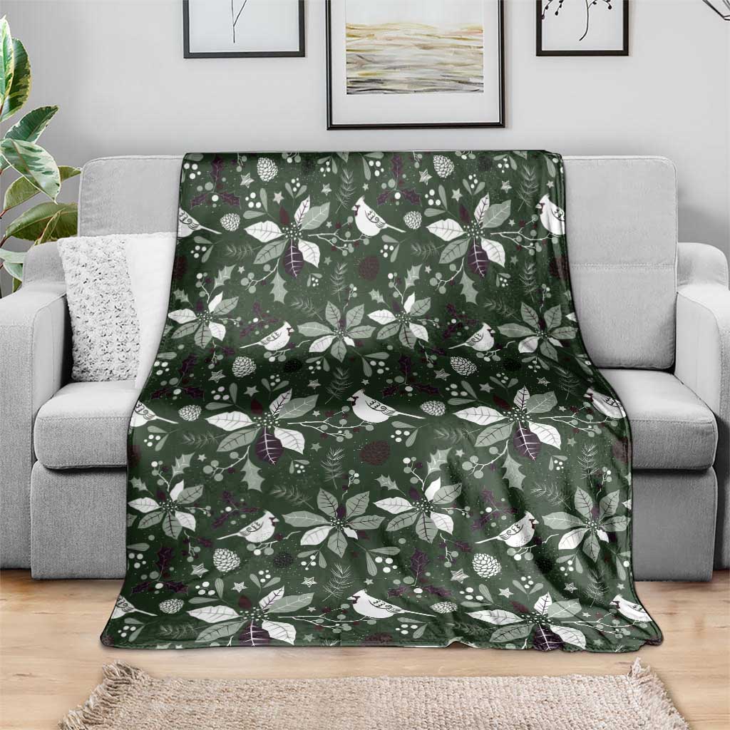 Green Christmas blanket with white bird and foliage pattern, laid out for viewing