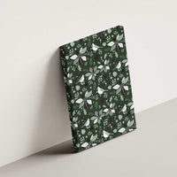 Green canvas wall art with bird-and-leaf Christmas pattern, mounted on wall.