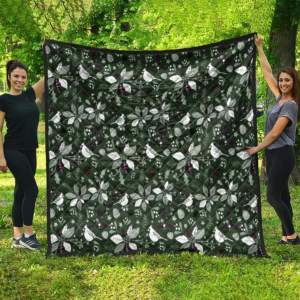 Green Christmas quilt blanket with white bow-and-leaf pattern and dark edge trim