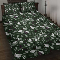 Green quilt bed set with white leaf and bird pattern, dark purple accents