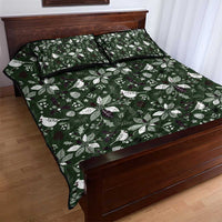 Green quilt bed set with white leaf and bird pattern, neatly spread on bed