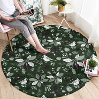 Green round carpet with festive white bird and holly leaf pattern