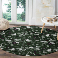 Green round carpet with white birds and dark purple berry leaf motifs