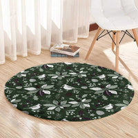 Green round Christmas carpet on wood floor with white bird and pine leaf design