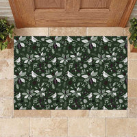 Green rubber Christmas doormat with white leaf and bird pattern, top-down view