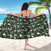 Green patterned sarong wrap with white birds and leaves; tied back coverage.