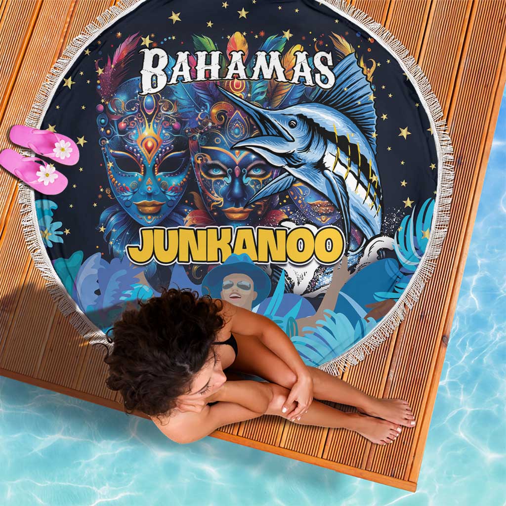Round blue beach blanket with white fringe, Junkanoo and Bahamas mask graphic, angled