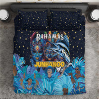Blue bedding set with star-pattern pillowcases and colorful Junkanoo masks on duvet