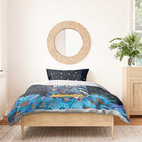 Blue bedding set with star-pattern pillows and Junkanoo masks artwork on duvet