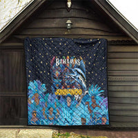 Blue quilt laid in wooden porch, stars with Bahamas Junkanoo mask and figures