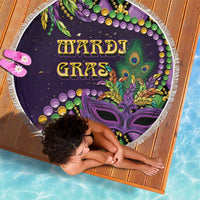 Round purple beach blanket with tassel fringe featuring fleur-de-lis and bead garland art
