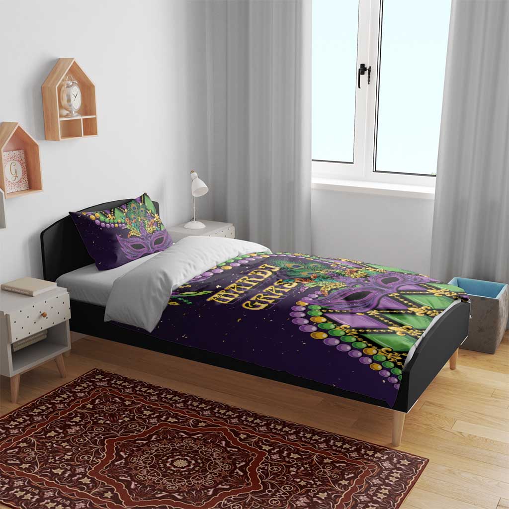 Purple Mardi Gras bedding set on a bed with two pillows, mask art and green accents